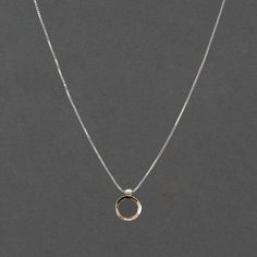 The ellipse form and circle come together in an arrangement that suggests a shell, a pearl or the symbol of Venus, creating a striking charm necklace that you'll love wearing everyday. This combination is timeless with the mixed metal elements of the gold hammered circle and silver ellipse form which slides along the glittering box chain. The charm is 5/8" long and 1/2" wide. This necklace has a 2" adjustable station so you may easily adjust the lengths. The model is shown wearing the 16/18" at 16" in the first picture and 18" in the second. FORM Collection Each piece of Haley Lebeuf Jewelry is individually crafted in the Austin, Texas studio. Pieces will have slight variations due to the nature of items made by human hands. Great effort is put into each item to ensure the highest quality, Elegant Open Circle Jewelry With Simple Design, Rose Gold Circle Necklace In Sterling Silver, Rose Gold Sterling Silver Circle Necklace, Rose Gold Circle Sterling Silver Necklace, Minimalist Full Circle Jewelry For Anniversary, Modern Open Circle Necklaces For Anniversary, Minimalist Open Circle Jewelry For Anniversary, Modern Open Circle Necklace For Anniversary, Minimalist Open Circle Anniversary Jewelry