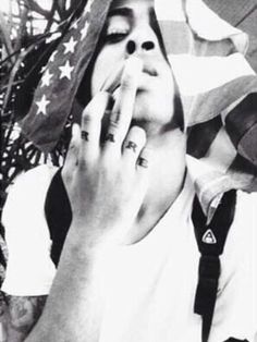 black and white photograph of a woman covering her face with an american flag on the background