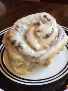 a cinnamon roll sitting on top of a white plate