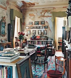 a room filled with lots of books and furniture