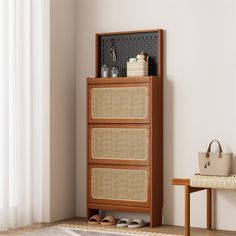 a wooden cabinet sitting next to a window with white curtains and a purse on top of it