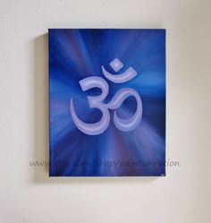 an om shan symbol painted on a canvas mounted to a wall