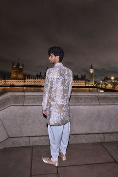 This sherwani set features all over ivory applique embroidery on a nude raw silk base and that is paired with matching silk kurta and an afghani salwar.From Seema Gujral's For the love of London collection. DELIVERY TIMEPlease allow 8-12 weeks for your outfit to arrive. FABRIC DETAILSRaw Silk Professional cleaning only.