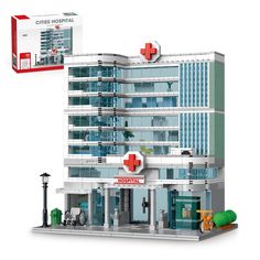 a building with a red cross on the front and white walls, is shown in lego form