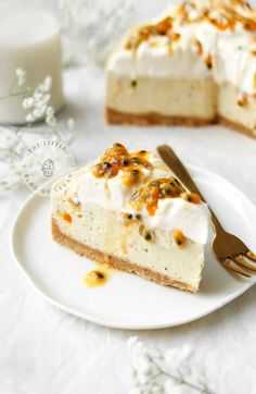 a piece of cheesecake on a white plate with a gold fork next to it