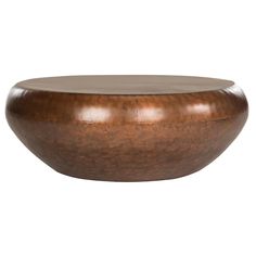 a large wooden bowl sitting on top of a white surface with no one around it