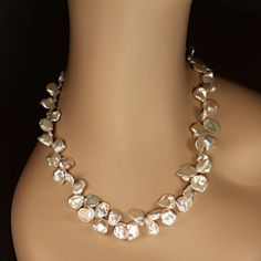 This is part of Chairish’s Fine Jewelry assortment.  Elegant 23-Inch Iridescent Keshi Pearl Necklace  This 23-inch necklace features exquisite white iridescent Keshi pearls, gently graduated in size from 9mm to 14mm. These uniquely shaped pearls, with their flat and rounded silhouettes, exude a luminous glow and captivating iridescence that effortlessly makes a statement.  Designed for both beauty and comfort, the necklace is secured with a versatile silver-plated toggle clasp featuring expandab Elegant Statement Necklace, Graduated Pearl Necklace, White Pearl Jewelry, Keshi Pearl Necklace, Iridescent Pearl, Kesha, Pearl Design, Keshi Pearls, Freshwater Cultured Pearls