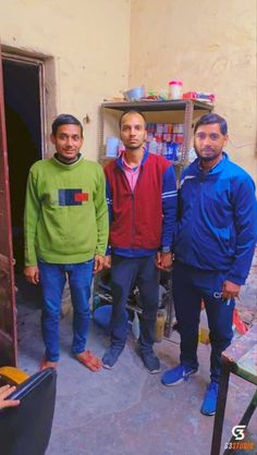 three men standing in front of a doorway