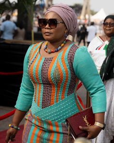 a woman wearing sunglasses and a colorful dress