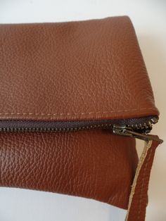 Genuine real leather brown simple everyday foldober zippered clutch bag. *Exterior High quality buttery soft supple pebbled real genuine leather. *interior - Fully lined with 100% natural cotton in chocolate brown. * Closes with YKK antique gold toned metal zipper closure. Approx. measurments (unfolded): Width -12 inches Height- 11.5 inches Versatile Brown Rectangular Clutch, Brown Soft Leather Pouch Clutch, Brown Leather Envelope Shoulder Bag, Versatile Brown Clutch For Everyday Use, Versatile Brown Clutch With Removable Pouch, Brown Clutch With Removable Pouch For Everyday, Everyday Brown Clutch, Brown Envelope Clutch With Removable Pouch, Brown Rectangular Clutch With Fold Over Clasp