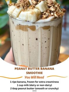 a banana smoothie is in a tall glass with whipped cream and toppings on top