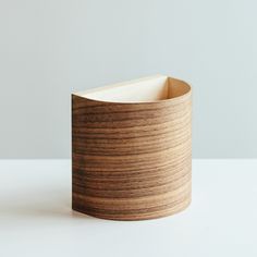 a wooden container sitting on top of a white table