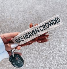 a person holding a car key in their left hand with the words wake haven grounded on it