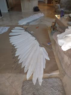 a large white bird sitting on top of a living room floor