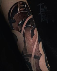 a man's arm with an abstract tattoo design on it, in black and grey