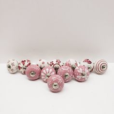 a group of pink and white ornaments sitting on top of a table next to each other