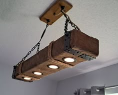 Recessed LED dimmable LED lights.  Farmhouse Style Chandelier Lamp. This is a handmade chandelier light lamp made from 3/4 inch pine wood planks. The height is 4.5 inches and the bottom width is 7.25 inches.  Choose your length. and color. It weighs about 12 lbs. The wood is distressed and aged. It has ax marks, saw cuts and burns. It hangs from the ceiling with 3/16 inch heavy black chain. It comes with the top ceiling mount board and swag hooks with butterfly or toggle type wall anchors to mount from your ceiling. The rope covered electrical cord feeds through the ceiling mount to hard wire to your existing receptacle. I include printed installation instructions. It has four dimmable recessed LED lights. I include two turnbuckles for hanging the lamp to the swag hooks and they are also f Rustic Cabin Lighting, Rustic Hanging Lights, Modern Rustic Lighting, Barn Beam Lighting, Cabin Kitchen Decor, Wooden Light Fixtures, Beam Lights, Farmhouse Style Lighting, Wood Light Fixture