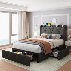 a bedroom with a bed, nightstands and large window overlooking the cityscape