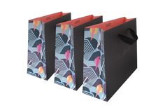 three black shopping bags with colorful designs on them