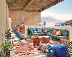 a living room filled with lots of furniture and decor on top of a wooden floor