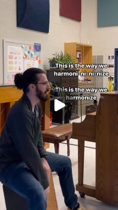 a man sitting on top of a wooden bench next to a piano in a room