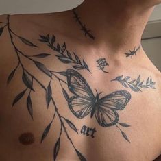 a man with tattoos on his chest has a butterfly and leaves tattoo on his chest