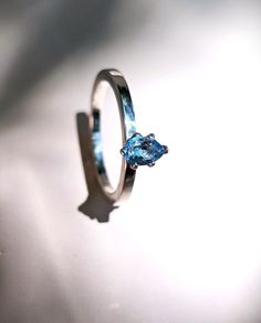 a close up of a ring with a blue stone