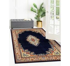 a blue rug with an ornate design on the floor in front of a white door