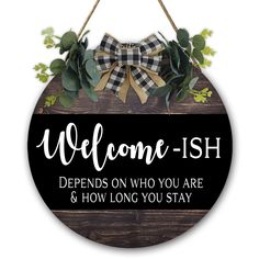 a wooden sign with the words welcome - ish on it, hanging from a rope