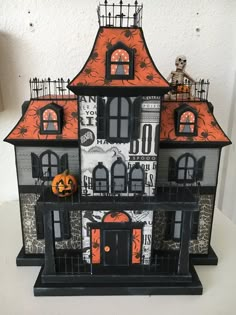 a black and white halloween house with pumpkins on it