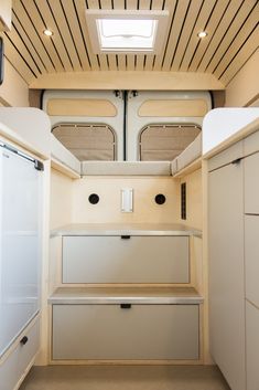 the inside of a small kitchen with white cupboards