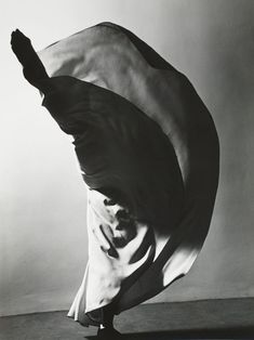 a black and white photo of a woman dancing