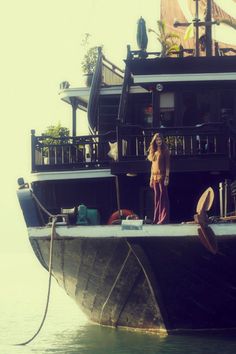 a man standing on top of a boat in the water