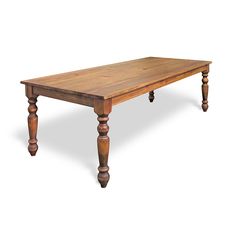 an old wooden table with turned legs on a plain white background is seen in this image