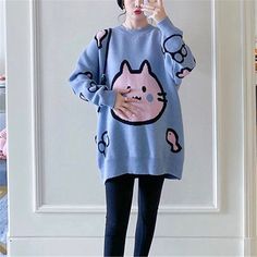 a woman wearing a blue color cute cat sweater for woman Oversized Kawaii Long Sleeve Sweater, Harajuku Winter Sweater With Cartoon Print, Harajuku Style Cartoon Print Winter Sweater, Kawaii Knitted Long Sleeve Sweater, Playful Oversized Knit Sweater, Oversized Playful Knit Sweater, Kawaii Long Sleeve Knitted Sweater, Kawaii Knit Sweater For Fall, Cute Knitted Acrylic Tops