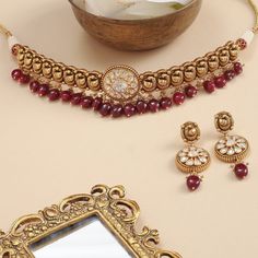 Description An opulent choker fit for a bride, this intricate gold plated silver neckpiece is the definition of regalia. A sequence of Mayurs have been expertly crafted out of the traditional Nakshi technique. This head-turner also features a moissanite studded center motif sparkling like the sun. Semi-precious rubies and pearl clusters add a royal charm to this choker set that come with an equally stunning set of drop earrings. Product Information Materials used: 925 Silver with Antique Gold Pl Festive Temple Jewelry Sets With Choker, Festive Temple Jewelry Choker Sets, Elegant Meenakari Jewelry For Rituals, Elegant Festive Kundan Choker, Elegant Kundan Jewelry For Rituals, Intricate Design Choker Necklace For Reception, Intricate Design Choker For Reception And Festivals, Intricate Design Choker For Receptions And Festivals, Festive Intricate Temple Choker Necklace