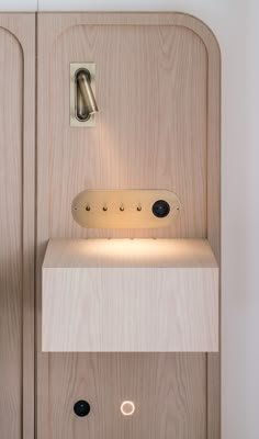 a wooden shelf with a light on it and some lights in front of the door