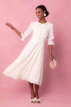 The Ruth Dress showcases a sheer material with a delicate lace peter collar detail. Her fit and subtle flare silhouette adds a touch of elegance, while the tea length provides a timeless look. The non-functional buttons on the bodice are charming and feminine, and the sophisticated cream color complete the design. Ivy City Women's Ruth Dress | Size: 14 White Dancing Dress, White Spring Dress, Confirmation Dresses, Ivy City Co, Pom Pom Dress, Lover Dress, Dancing Dress, Shower Outfits, Modesty Outfits