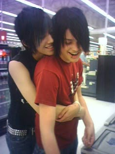 two people hugging each other in a store