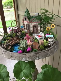 a potted planter filled with lots of different types of plants and houses in it