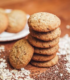 a stack of cookies sitting on top of a table next to oatmeal