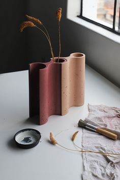 three vases sitting on top of a white table