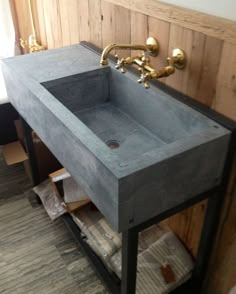 a bathroom sink sitting under a faucet next to a wooden paneled wall