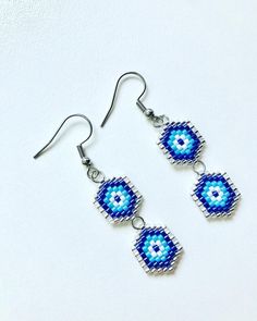 - Silver stainless steel seed beads handmade blue evil eye hook earrings - Earrings length is 4.5 cm (1.8 inches) - Miyuki seed beads, stainless steel - Colors may appear slightly different on screen due to differences in resolution, brightness, and contrast JEWELRY CARE - Keep jewelry dry - Take it off before taking shower, bath, swimming or exercising - Makeup, perfume, hairspray apply before wearing jewelry - Store your jewelry somewhere dry, not in the bathroom Handmade in Cyprus PACKING All Handmade Blue Teardrop Jewelry, Handmade Minimalist Beaded Earrings For Gift, Blue Metal Beaded Earrings For Gift, Handmade Metal Beaded Earrings With Round Beads, Handmade Minimalist Beaded Dangle Earrings, Handmade Turquoise Beaded Metal Earrings, Handmade Turquoise Beaded Earrings, Handmade Blue Beaded Metal Earrings, Minimalist Handmade Beaded Dangle Earrings