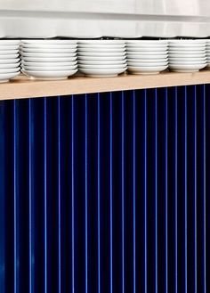 plates are stacked on top of each other in front of a blue metal radiator