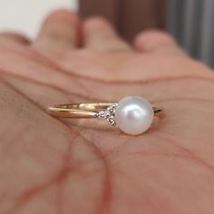 **KINDLY CHECK OUT THE VIDEO OF THE ITEM FOR A CLEARER VIEW**Details of the ring Gemstone: Center Gem: Pearl gem shape,size & weight: Round, 6 mm & 1.15 carats Side Gem: Diamond gem shape,size & weight: Round, 1.20 mm (6 pcs) & 0.04 carats Total Stone Weight: 1.19 carats Metal: GOLD Purity: 14 KT Weight: 1.29 Grams Total weight of the ring: 1.53 grams Beautiful Pearl and Diamond set in 14kt Gold, a perfect gift for a woman. The Gold purity is absolutely guaranteed and it comes wi 14k Gold Pearl Ring With Gemstone For Wedding, Fine Jewelry Pearl Ring For Promise, 14k Gold Pearl Ring With Gemstone, 14k Gold Pearl Promise Ring, 14k Gold Pearl Ring With Diamond Accents, 14k White Gold Pearl Ring With Gemstone, 14k Gold Pearl Ring With Prong Setting For Promise, 14k Gold Pearl Ring Fine Jewelry, 14k Gold Pearl Ring With Gemstone For Anniversary