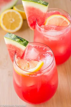 two glasses filled with watermelon lemonade and cucumber garnish