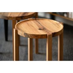 two wooden tables sitting next to each other on top of carpeted flooring in a room