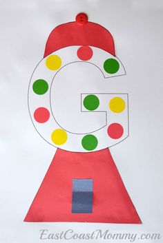 the letter g craft is made with construction paper and colored circles on it's surface