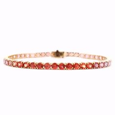 Elevate your style with our exquisite 9.37 Cts. Pink to Red Sapphire & Ruby Tennis Bracelet. Crafted with precision, this bracelet features stunning gemstones that range from vibrant pink to deep red, offering a unique and luxurious touch to any outfit. Make a statement and indulge in luxury with this exclusive piece. GEMS 9.37 RD TCW 48 PCS. RED TO PINK18K YG 10.34 GRAMS SIZE 7" MD-122 Luxury Red Women's Tennis Bracelet, Red Sapphire, Tennis Bracelet, Deep Red, Ruby, Tennis, Sapphire, Gems, Size 7